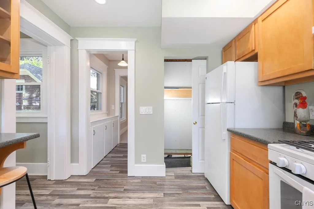 This view shows the various doorways in the kitchen. To the left is the doorway to the mudroom, in the center is the doorway to the butler\'s pantry, and the pocket door to the right leads to the basement steps.