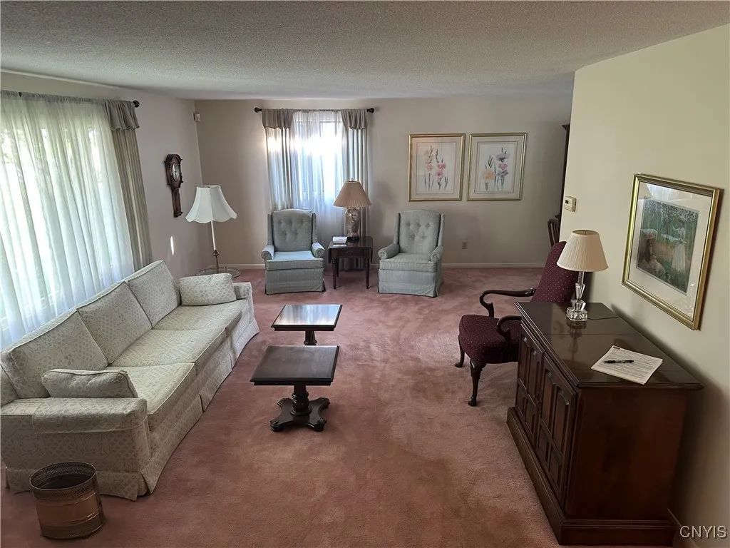 living room (unfinished hardwoods under carpet)