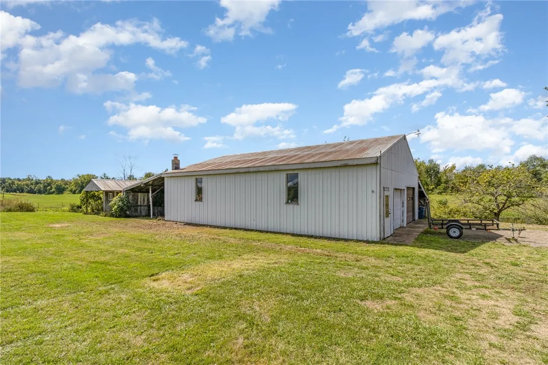 Huge two bay garage with car lift, plus covered storage