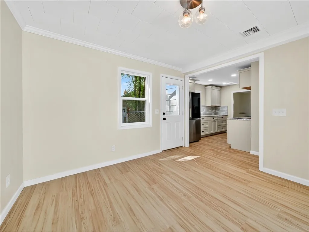 Great room looking into kitchen and side entry door