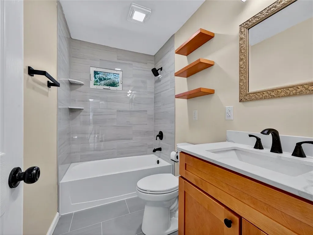 Beautiful New bathroom with custom tile shower and floor. Wood floating shelves