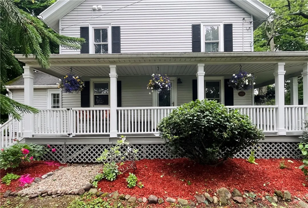A view of the gardens and porch from the circular driveway