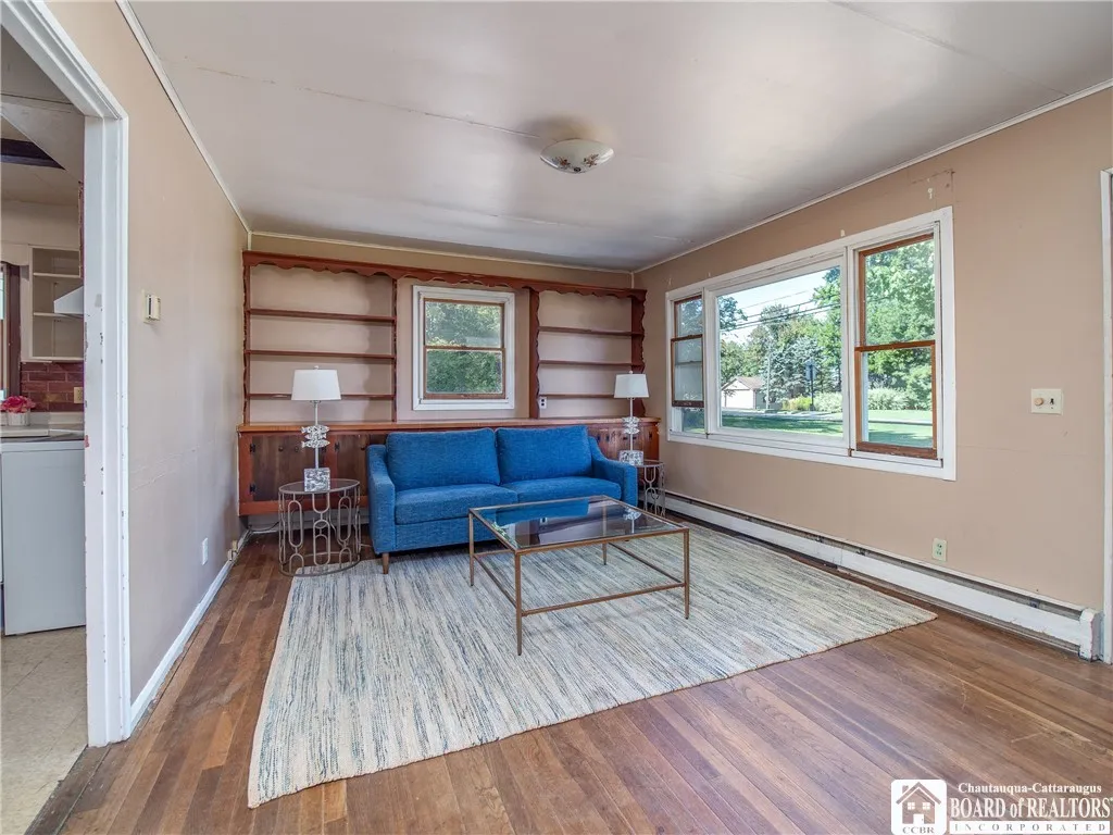 The living room located in the front of the home features original hardwood flooring.