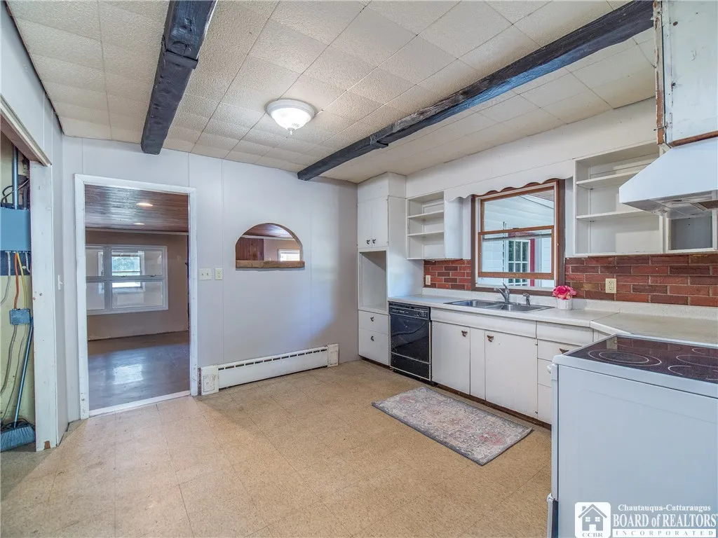 Kitchen connects from the family room to the sitting room in the front of the home.