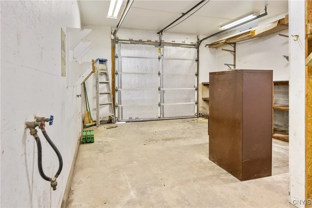 Attached basement garage with additional storage room