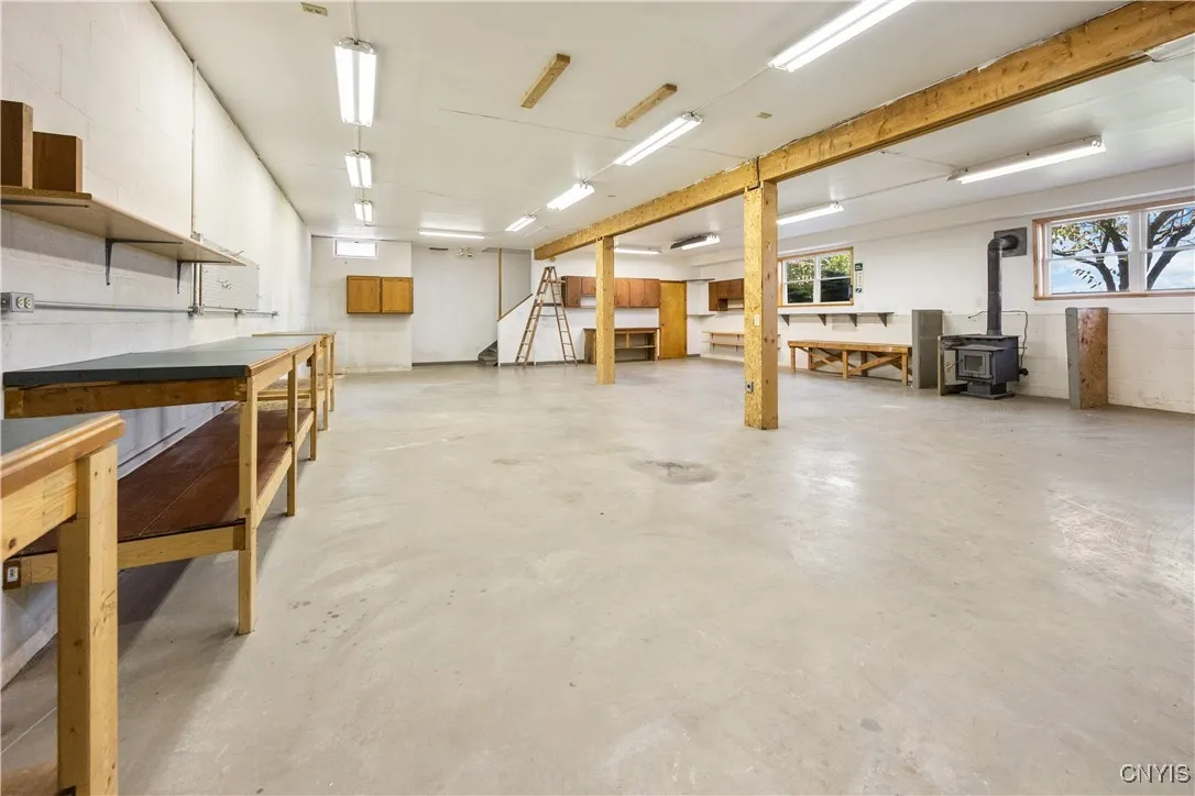 Partially finished full walk out basement with wood stove, storage room, utility room, half bath plus attached garage and storage room