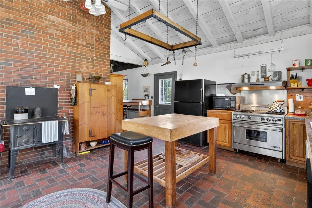 Center Island made from bowling alley flooring and restaurant size gas stove