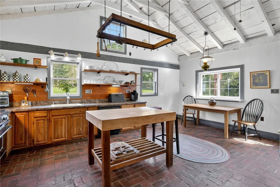 Kitchen with brick floors and cathedral ceiling