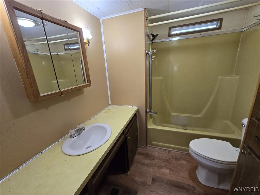 bathroom with shower - washer / dryer area behind door