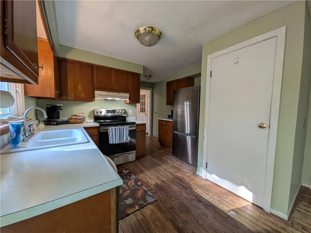 To the back, you'll find the 1st flr 1/2 bath, and the mudroom.