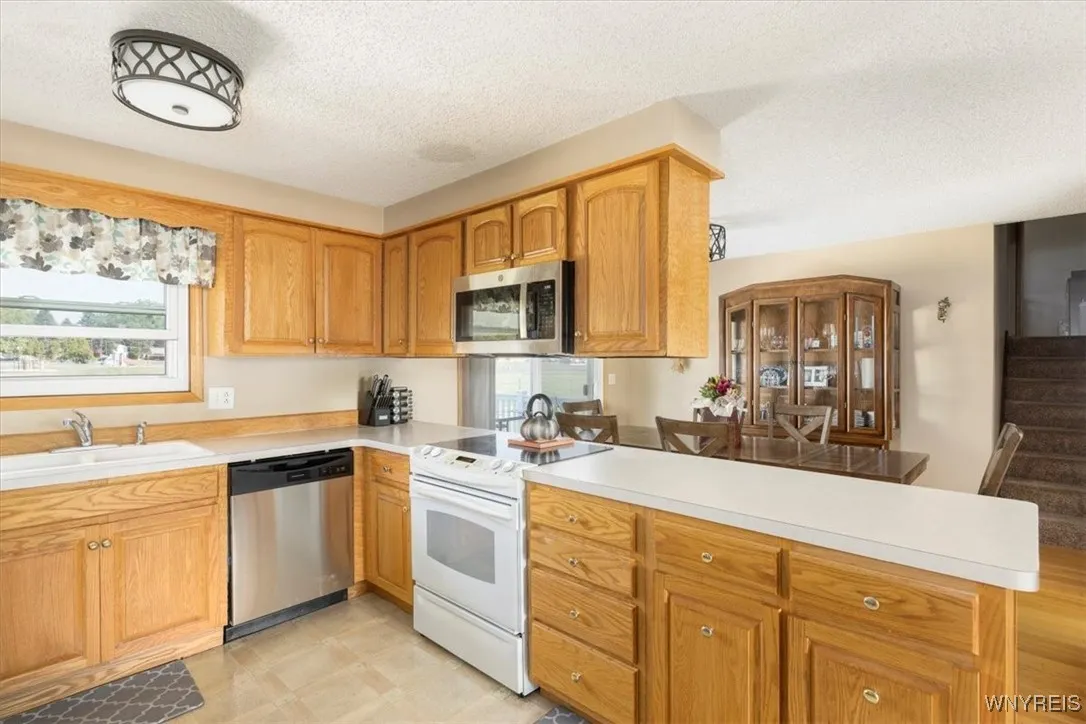 Open kitchen with pass through serving. brand new dishwasher.