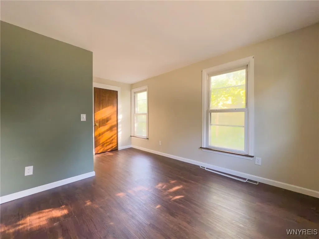 Bedroom 1 with hardwood flooring
