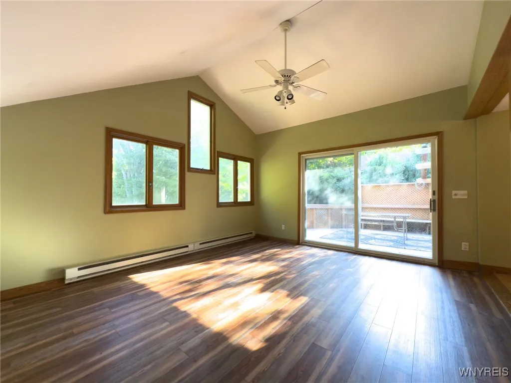 Family room with vaulted ceiling and scratch proof vinyl plank flooring