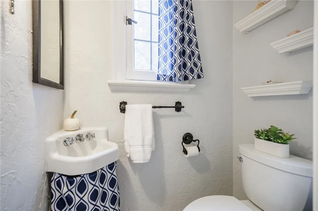 Half bath on the 1st floor with the cutest corner sink!