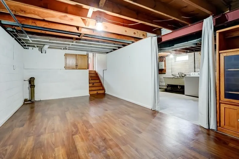 New paint, new flooring and wall separating recreation space from the laundry and mechanicals.
