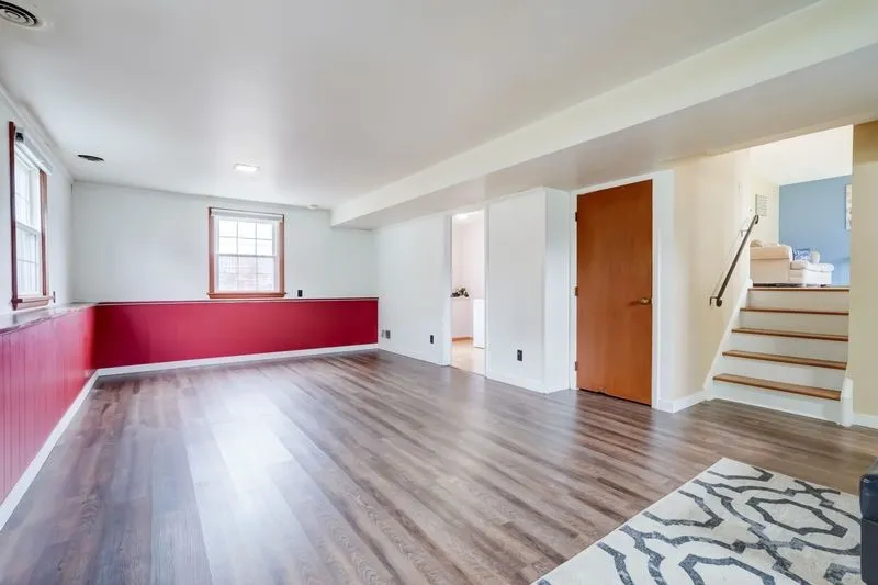 View looking towards the rear of the home. The closed door to the right leads to even more recreation and storage space in the true basement level!