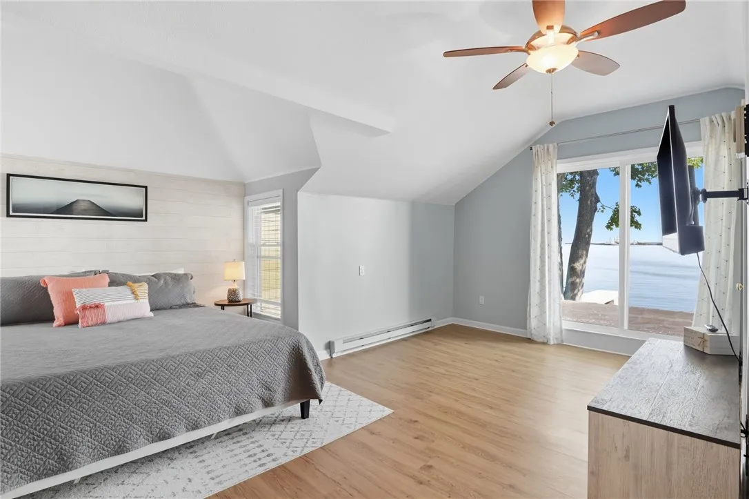 Primary bedroom with ensuite and sliding glass doors out to roof deck.