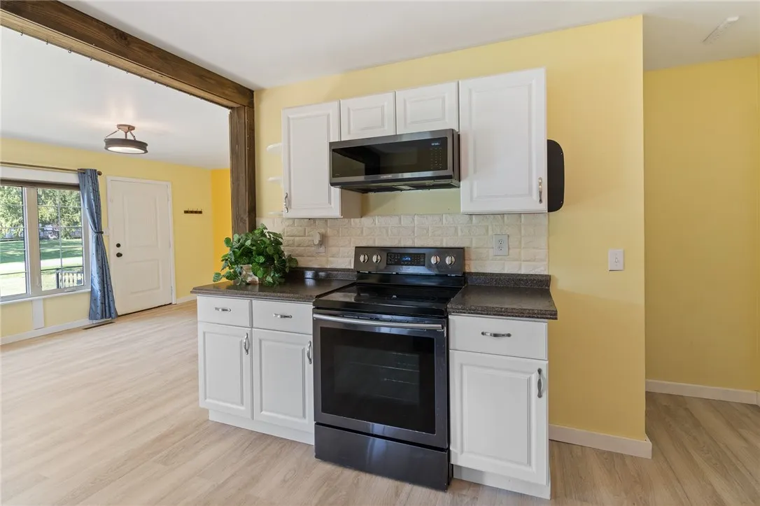 The easy to clean WHITE CABINETRY makes this space flow and the colors are super simple to decorate around!