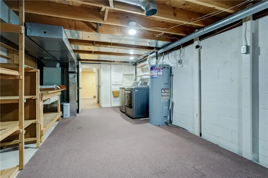 another view of the laundry/storage area with furnace and hot water heater