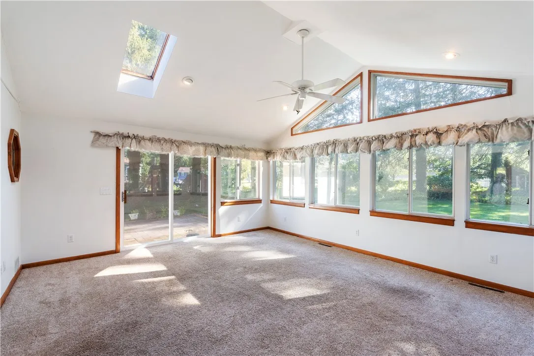 Walls of windows overlooking private, treed lot.
