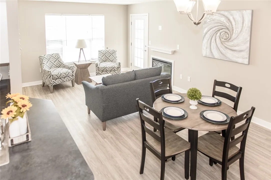 Typical great room with plank flooring and bright, sunny windows