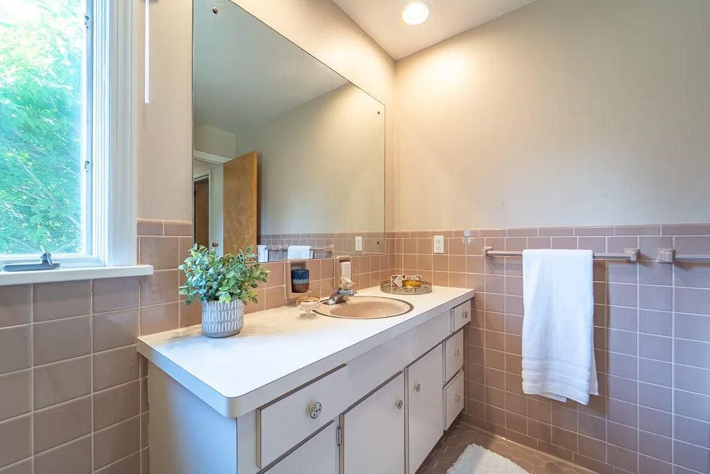 These bedrooms share a tiled family bath with shower and tub.