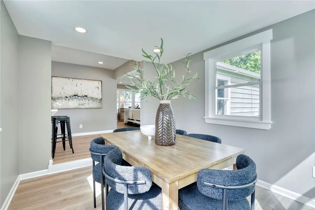 Sun-drenched morning room with oversized windows, perfect for dining or relaxing.