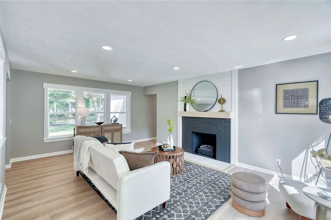 Open concept living anchored by a stylish fireplace feature wall
