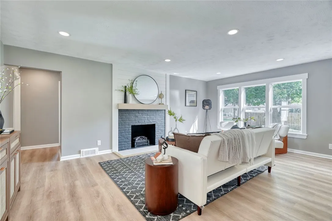 Open concept living anchored by a stylish fireplace feature wall