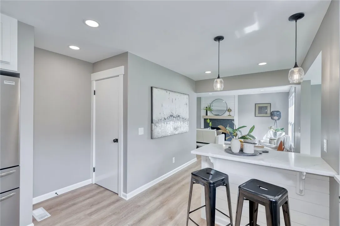 Breakfast bar seating and open flow to the living and dining spaces