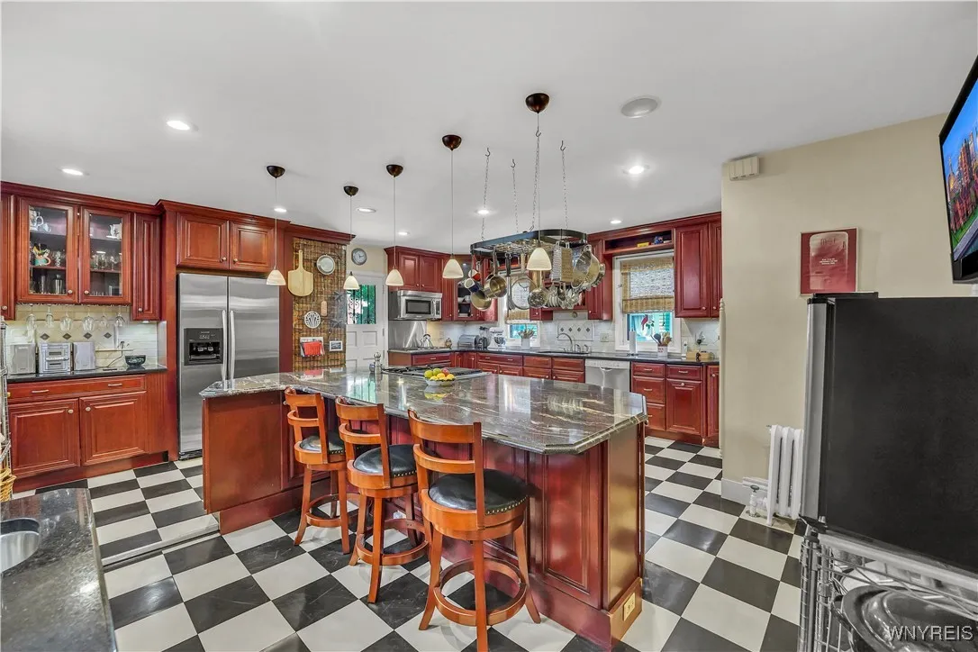 Oversized island with breakfast bar area and...