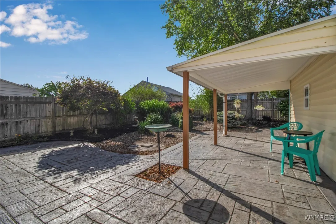 Fully fenced yard with stamped concrete patio