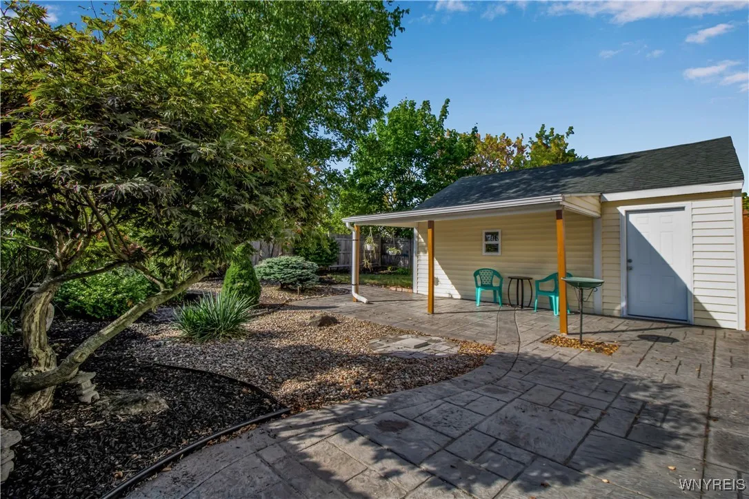 Fully fenced yard with stamped concrete patio