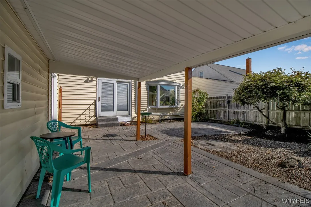 Fully fenced yard with stamped concrete patio