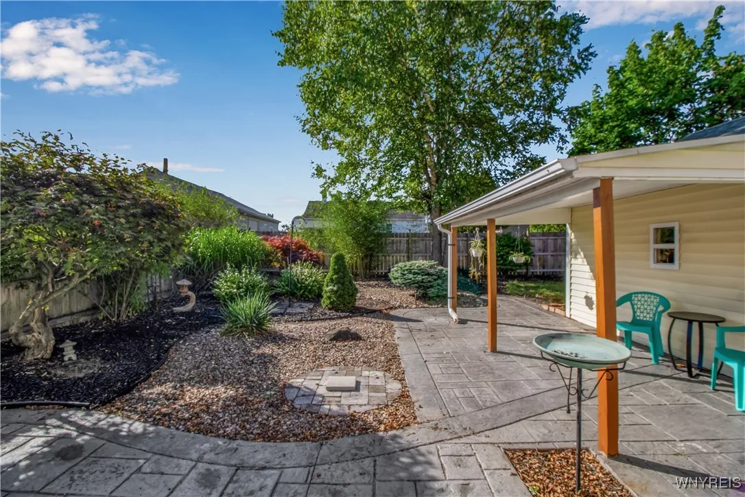 Fully fenced yard with stamped concrete patio