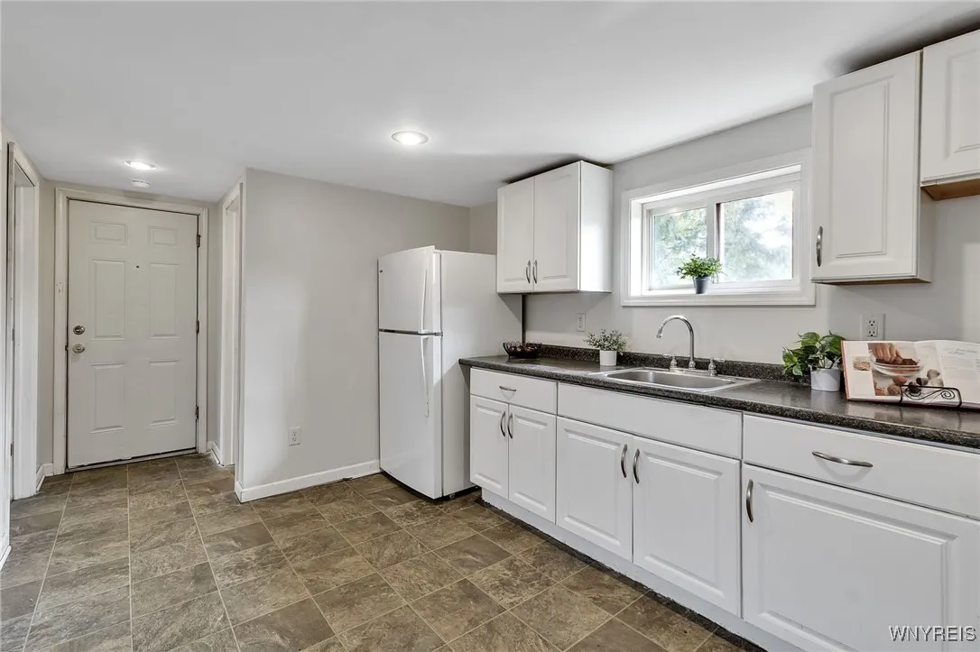 Entrance door is on left in this photo leading from upper hallway to upper right apt