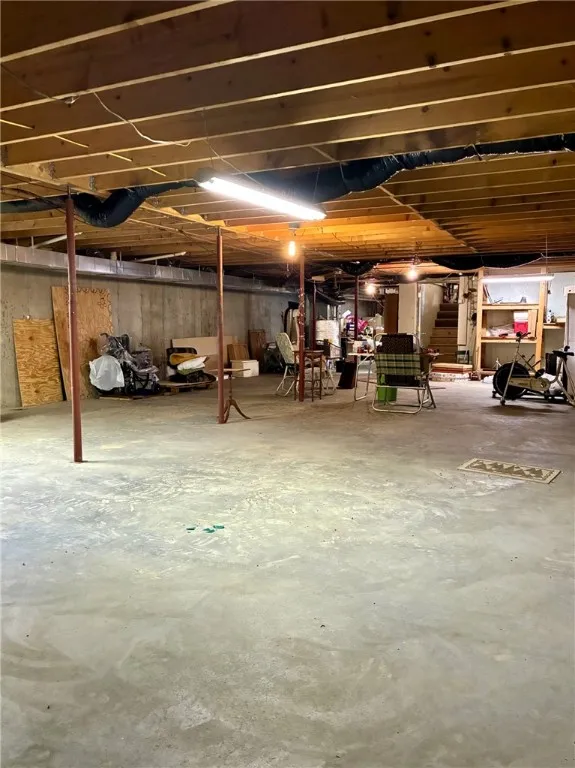 This basement is enormous! The concrete floor, built-in shelves and space make it possible to use for just about anything.