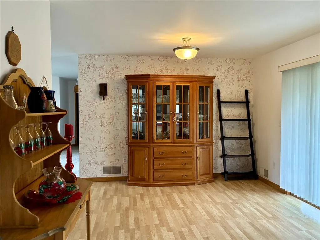 This dining room is perfect for any holiday gathering. Very pretty vinyl plank flooring spans the dining room and kitchen.