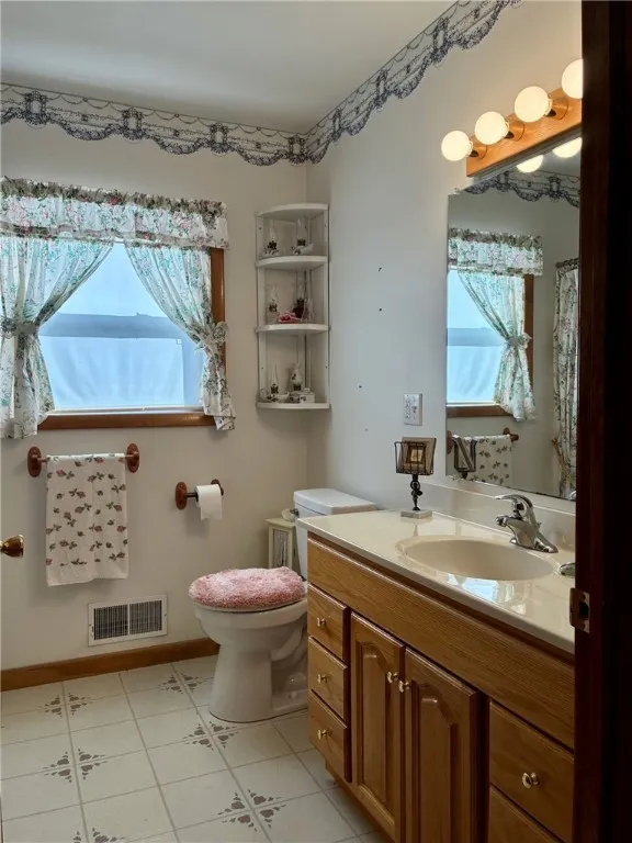 Between both guest bedrooms is this full bathroom with a tub/shower combination and a vanity with lots of counterspace.