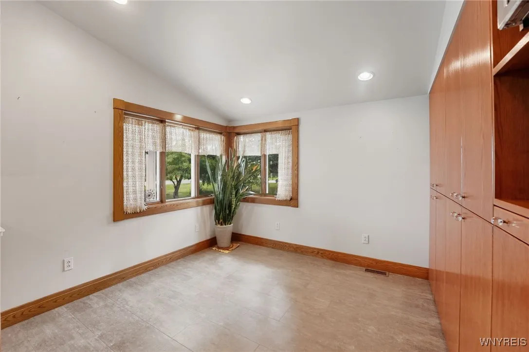 Eating area in kitchen with corner windows.