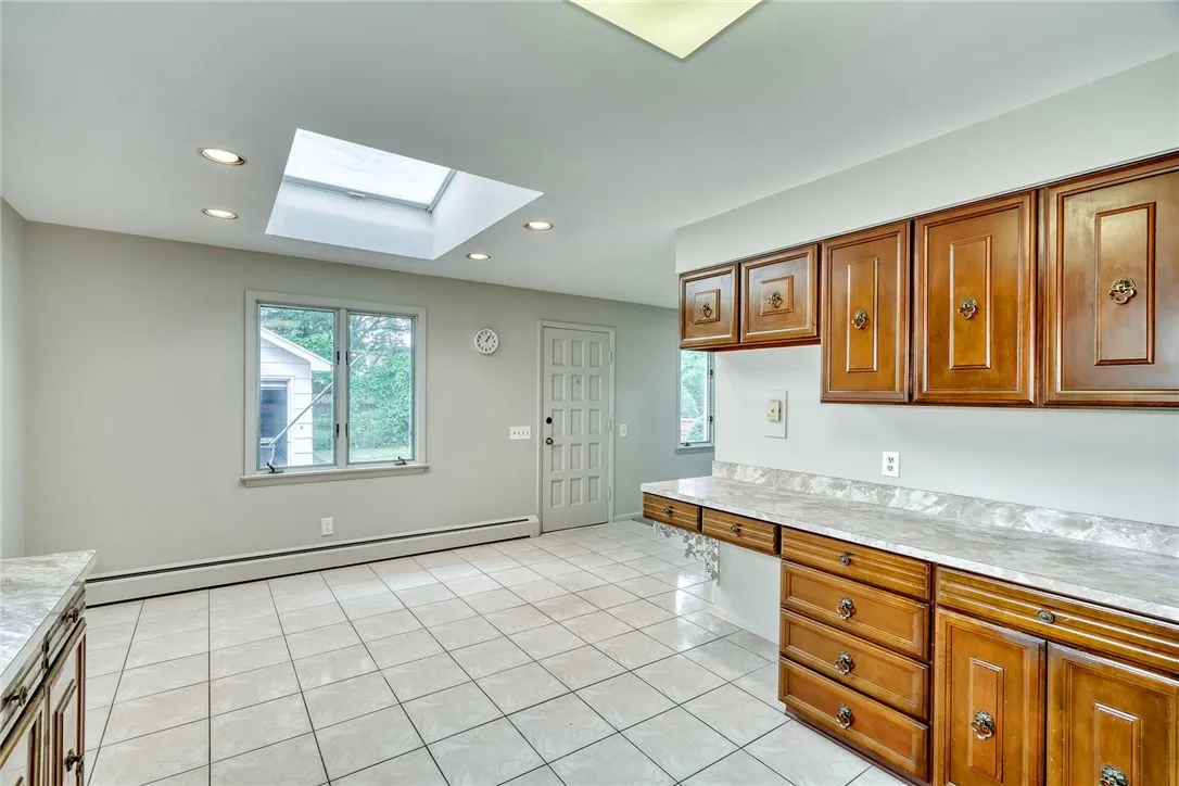 Rear window and skylight make breakfast cheery and bright . . .