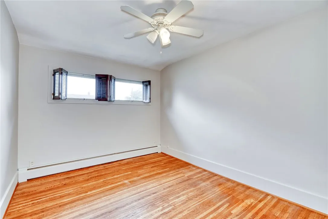 Center room at top of the stairs used as a bedroom . . . with ceiling fan