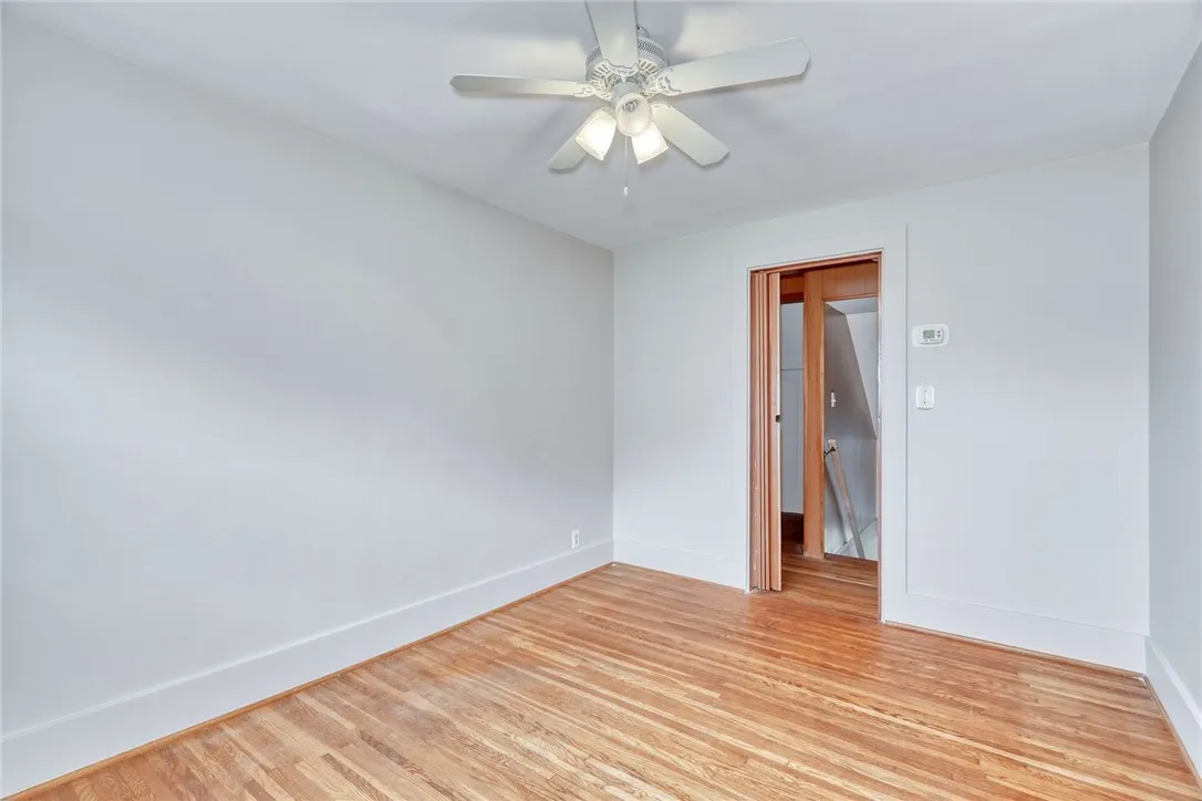 Center room at top of the stairs used as a bedroom . . . view back into the hallway and stairs
