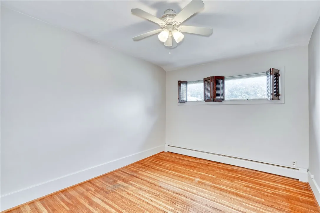 Center room at top of the stairs used as a bedroom . . . hardwood floor