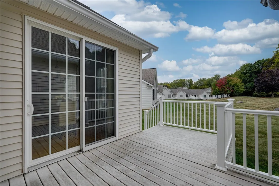Private deck overlooks green space.
