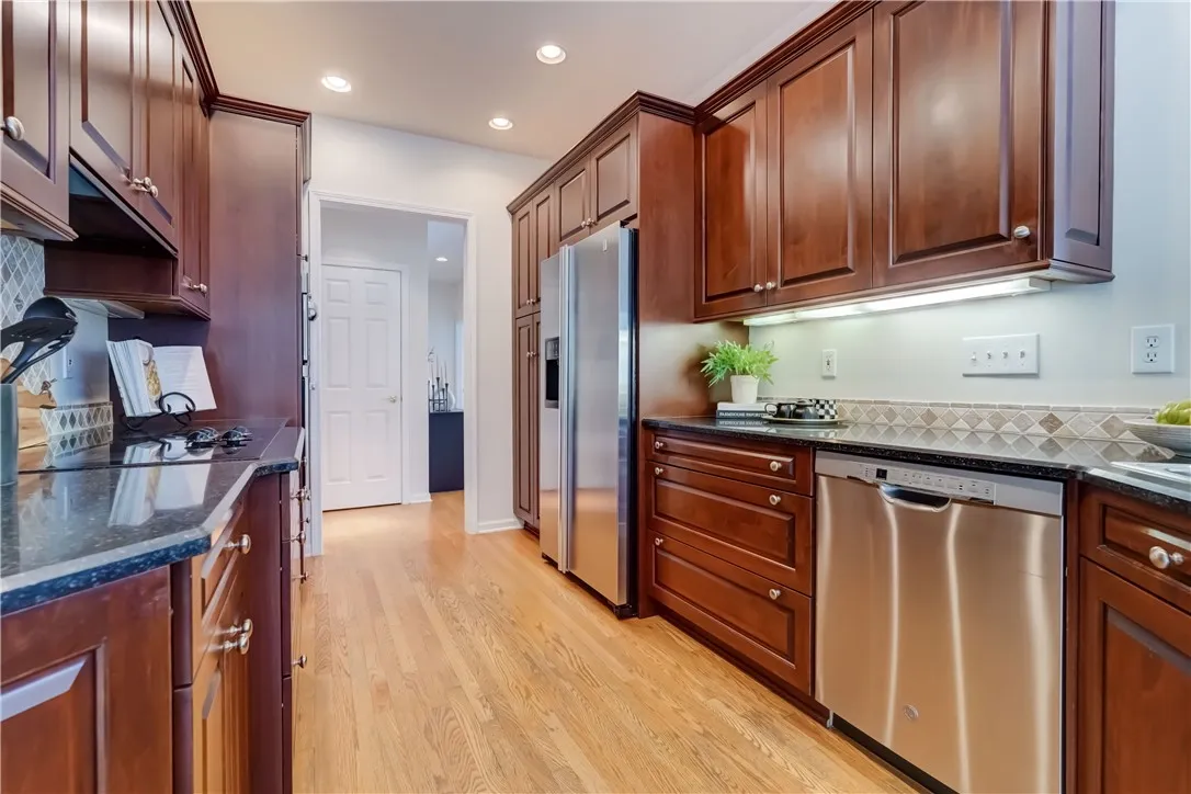 Kitchen with cherry cabinets, granite counter tops, stainless appliances.