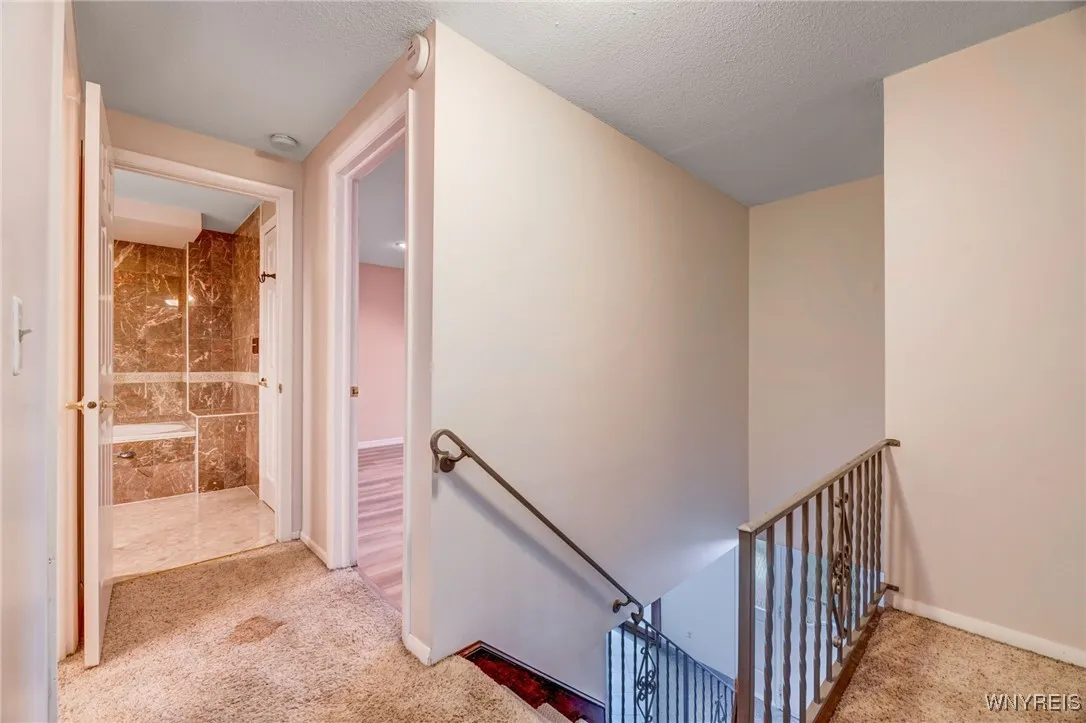 Entry to the full bath which is split between bedroom #1 and upper hall way.  There is also a 1/2 bath with shower in this hallway as well.