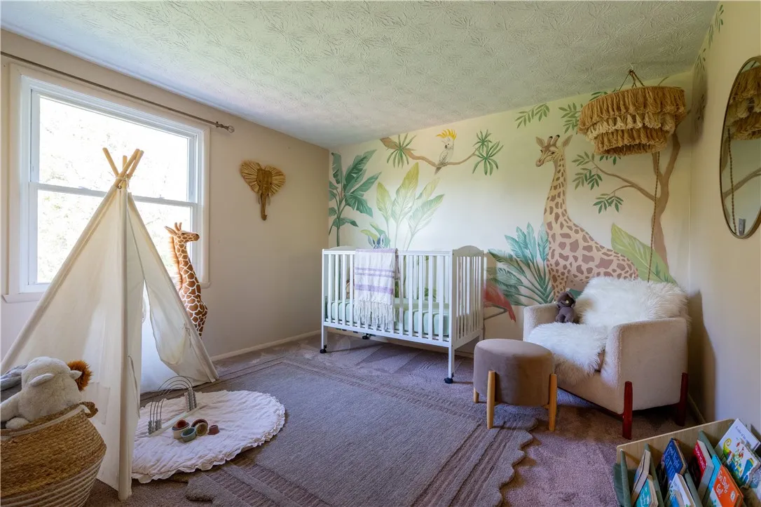 Second bedroom serves well as a nursery - custom painted mural!