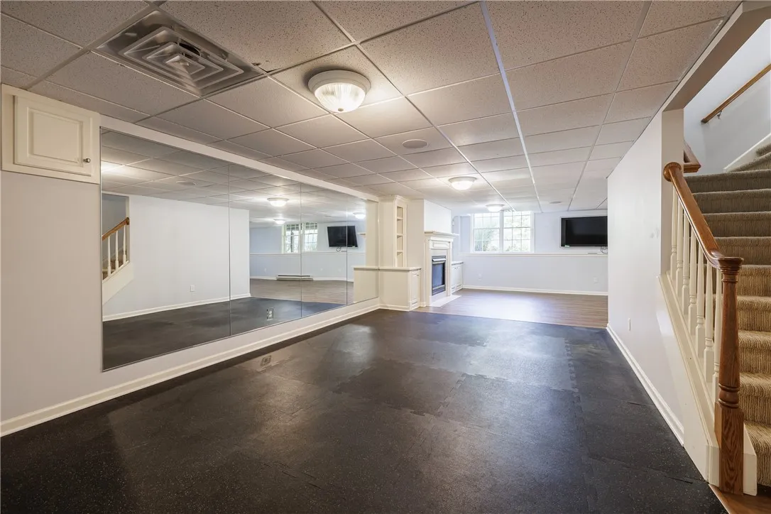 Finished basement with professionally-outfitted workout area
