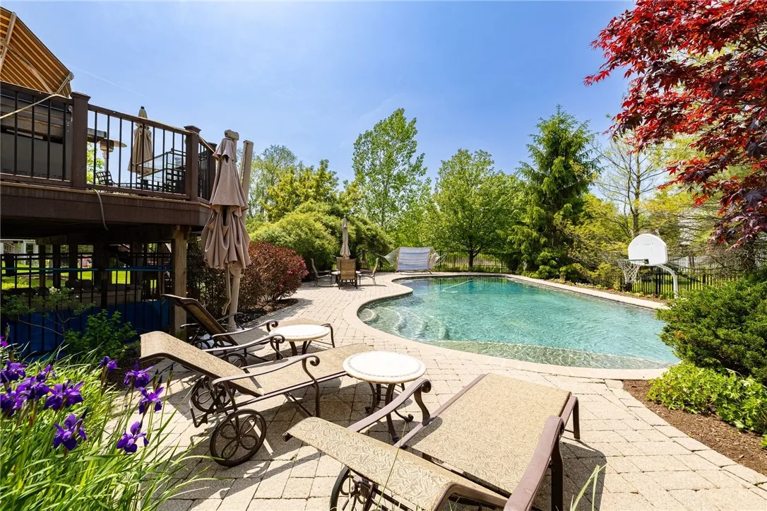 Paradise awaits you.  All poolside furniture conveys with the house, if desired